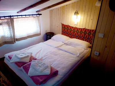 a bedroom with a bed with towels on it at Ethno art maisonette in the center of Sofia - plus Free Vouchers & Gift in Sofia