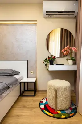 a bedroom with a bed and a circular mirror at Urban Lux Apartments Center of Plovdiv by Flat Mаnager in Plovdiv