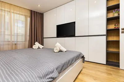 a bedroom with a bed and a flat screen tv at Urban Lux Apartments Center of Plovdiv by Flat Mаnager in Plovdiv