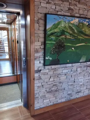 a brick wall with a painting on it at Pirin Golf - NIRVANA, Studio&SPA in Razlog