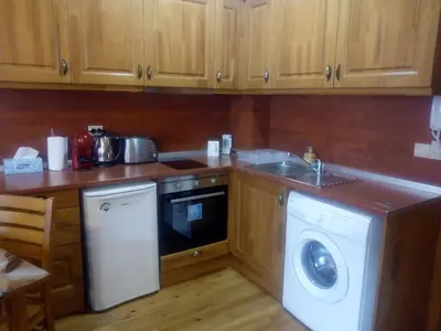 a kitchen with a washing machine and a sink at Pirin Golf - NIRVANA, Studio&SPA in Razlog