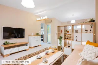 a living room with a couch and a tv at Super Central Stylish Suite & Studio with Shared Terrace by Flat Mаnager in Sofia