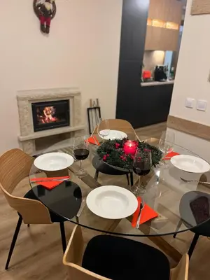 a dining room table with plates and glasses of wine at Grand resort luxury apartment in Pamporovo