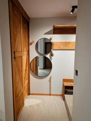 a hallway with a door and a mirror at Pine & Wine Sauna Apartment in Pamporovo