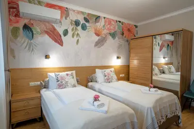 a hotel room with two beds and a mirror at SP Urban Apartment in Plovdiv