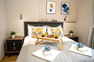 a bedroom with a bed with a tray of food on it at SP Urban Apartment in Plovdiv