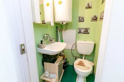 a bathroom with a toilet and a sink at The White Apartment 3BR - free parking in Sofia