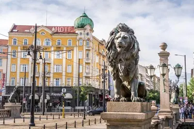 a statue of a lion in front of a building at The White Apartment 3BR - free parking in Sofia