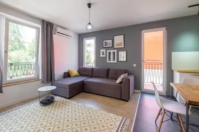a living room with a couch and a table at Industrial Look Apartment Top Centre + Free Parking in Sofia