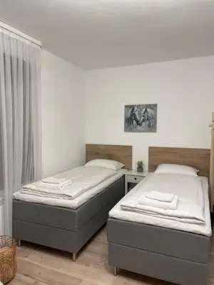 a bedroom with two beds and a window at Апартамент Никола и Мария in Sapareva Banya
