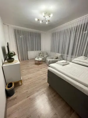 a bedroom with a bed and a living room at Апартамент Никола и Мария in Sapareva Banya