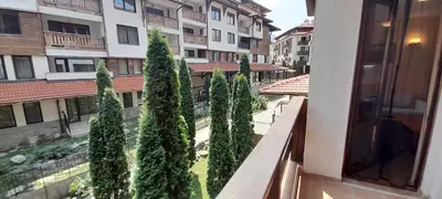 a view from the balcony of a building with trees at Ski-in ski-out Fantastic Apartament in Bansko