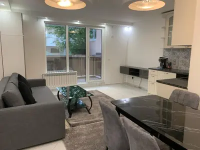 a living room with a couch and a table at Top Central Apartment & Free Parking in Sofia