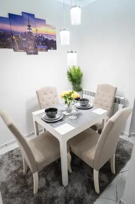 a dining room table with two chairs and a white table at Top Central Apartment & Free Parking in Sofia
