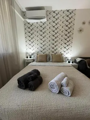 a bedroom with two towels on a bed at Studio John's in Blagoevgrad