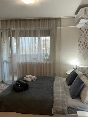 a bedroom with a large bed with two towels on it at Studio John's in Blagoevgrad