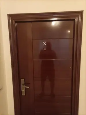 a person standing behind a door with the number at Studio John's in Blagoevgrad