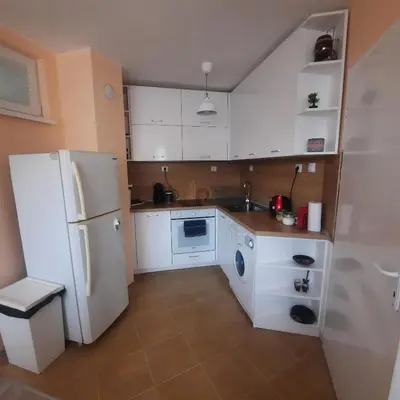 a kitchen with a white refrigerator and a washer at 