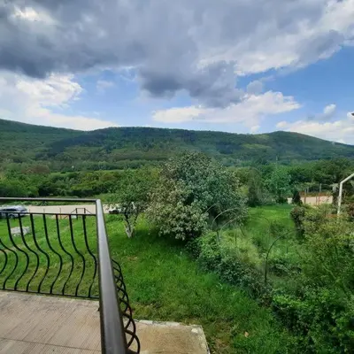 a balcony with a view of a lush green field at 