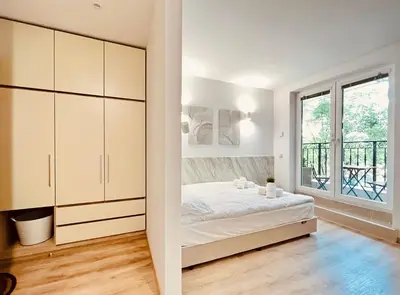 a bedroom with a bed and a window at Apart-Hotels-Sofia, AHS in Sofia