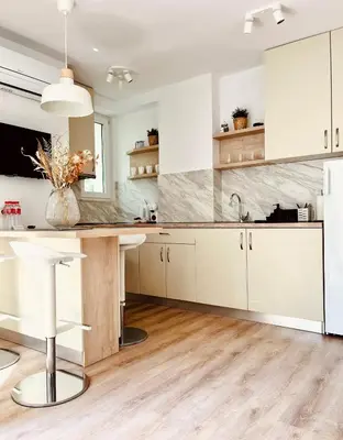 a kitchen with white cabinets and a counter at Apart-Hotels-Sofia, AHS in Sofia