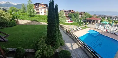 a view of a swimming pool and a garden at Green life, Bansko, private studio c-17 in Bansko
