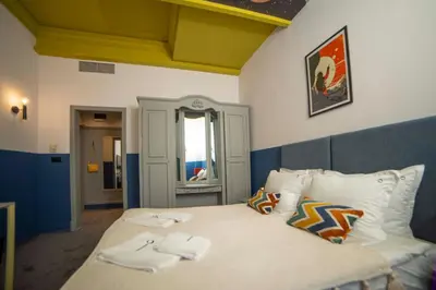 a bedroom with a bed with towels on it at Maria Luisa by INTROVERT HOTELS in Sofia