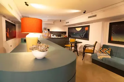 a living room with a table and a couch at Maria Luisa by INTROVERT HOTELS in Sofia