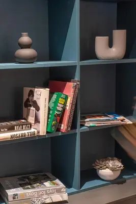 a book shelf filled with books and magazines at Maria Luisa by INTROVERT HOTELS in Sofia