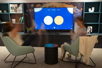 two people sitting in chairs in front of a tv at Maria Luisa by INTROVERT HOTELS in Sofia