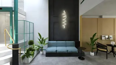 a living room with a blue couch and a table at Maria Luisa by INTROVERT HOTELS in Sofia