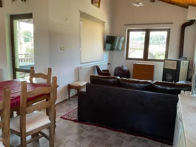 a living room with a couch and a table at Three Graces in Banya