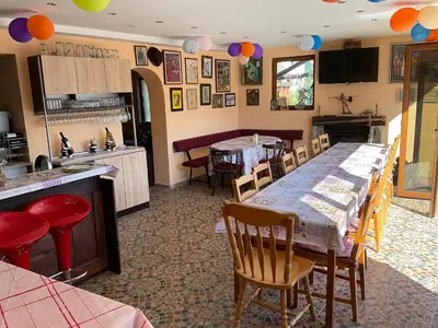 a kitchen and dining room with a table and chairs at Three Graces in Banya