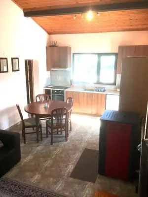 a kitchen and dining room with a table and chairs at Three Graces in Banya