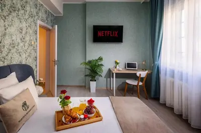 a hotel room with a tray of fruit on a bed at Free Parkingand Relax in Sofia