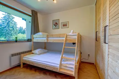 a bunk bed in a room with a window at Villa Kometa Pamporovo Cozy 1-BD Flat by Flat Mаnager in Pamporovo