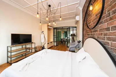 a room with a bed and a brick wall at Heart of the Center, 2Bedroom View Lux Apartment in Sofia