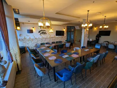 a large dining room with a long table and chairs at Pine & Wine Bathtub Apartment in Pamporovo