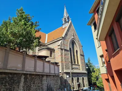 a church with a steeple on top of a building at VIEW hill plovdiv in Plovdiv