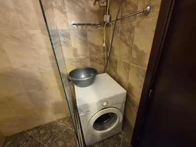 a small bathroom with a washing machine and a toilet at Elit Pamporovo Accommodation in Pamporovo