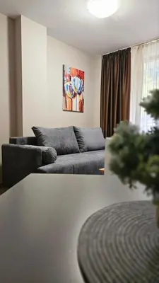 a living room with two couches and a table at Minkov Apartments, Пампорово - Замъка 2 in Pamporovo
