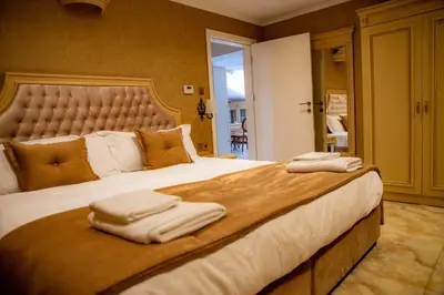 a bedroom with a large bed with towels on it at Luxury Apartment Rich 2 in Velingrad