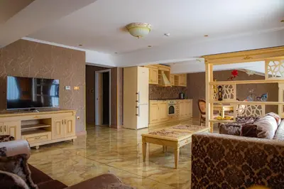 a large living room with a couch and a tv at Luxury Apartment Rich 2 in Velingrad