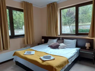 a bedroom with a bed with two towels on it at Terra complex -D6 - Balkan private apartment-Spa Sking Golf and Relax in Razlog