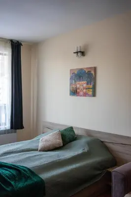a bedroom with a bed with a pillow on it at Sunny studio in Pamporovo in Pamporovo