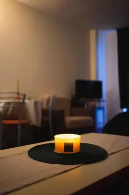 a candle on a table in a living room at Sunny studio in Pamporovo in Pamporovo