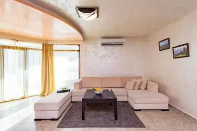 a living room with a couch and a table at Forest Nook Villas in Pamporovo