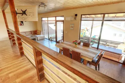 a dining room with a wooden table and chairs at Етно комплекс 