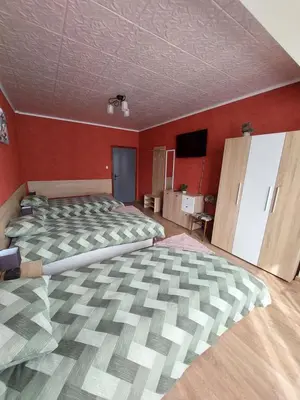 a large bedroom with a large bed and red walls at Familia Apartments in Samokov