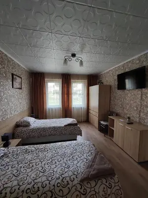 a bedroom with two beds and a tv on the ceiling at Familia Apartments in Samokov